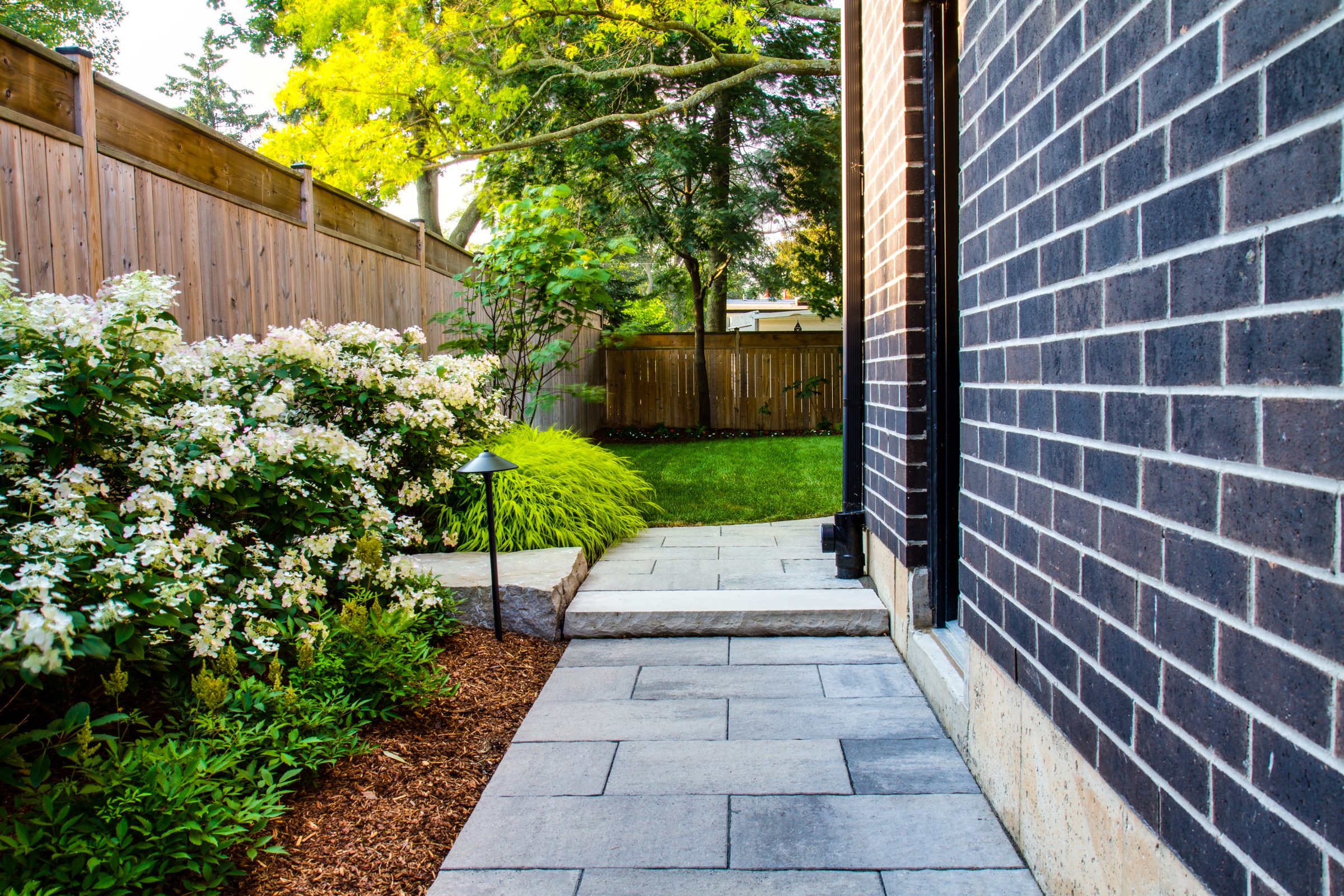 Garden with a stone pathway and greenery.
