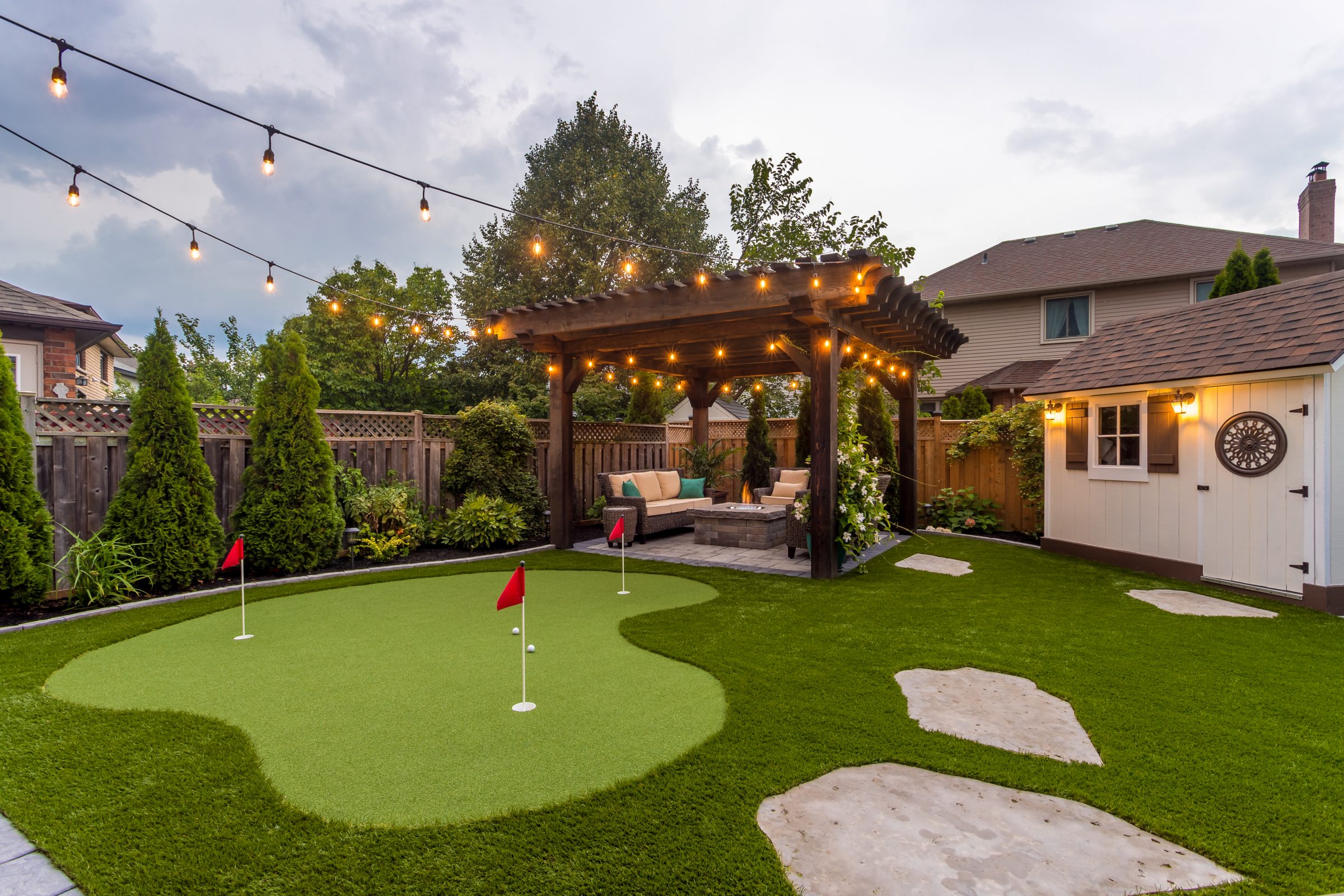 Backyard oasis with pergola and putting green.