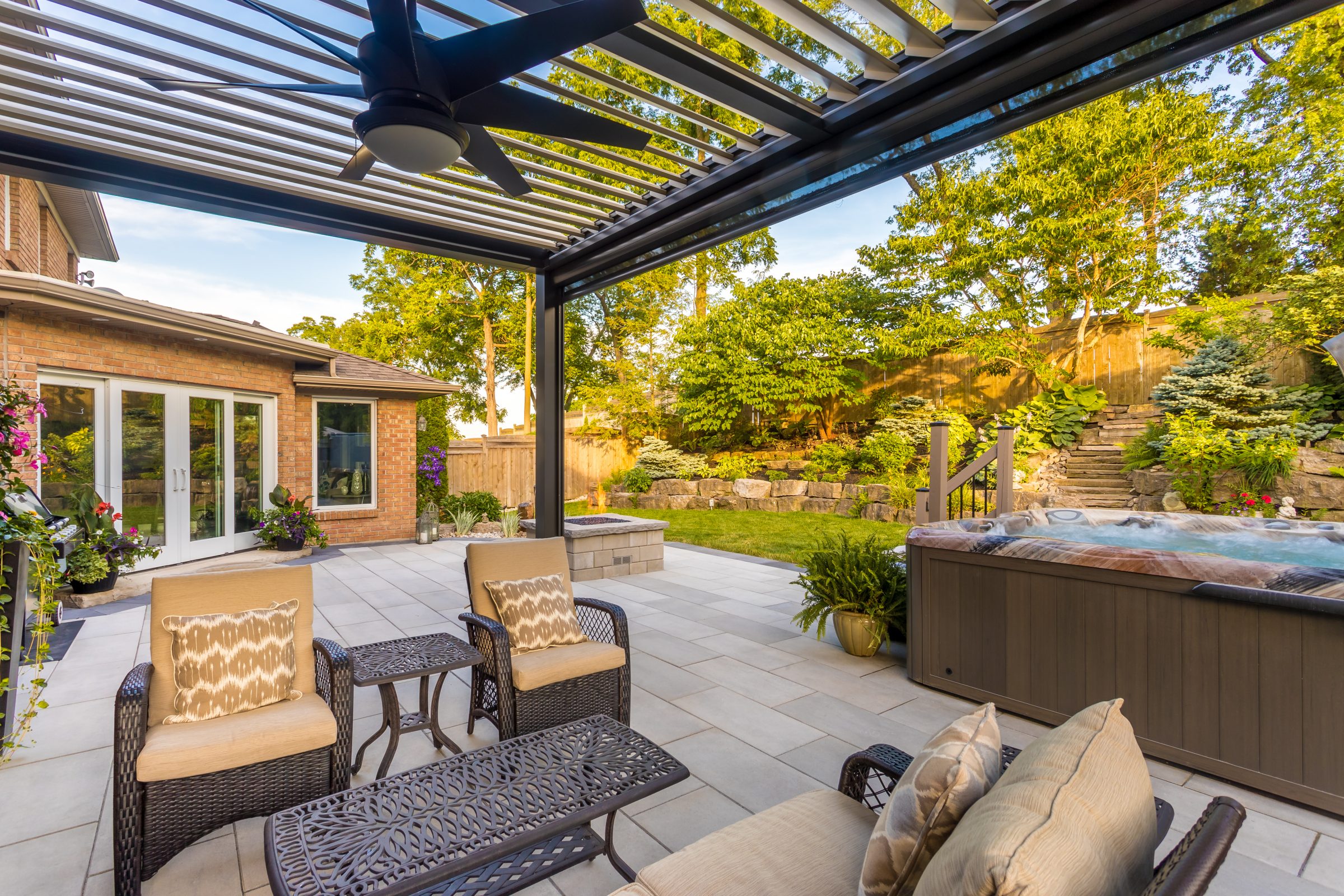 Modern patio with spa and outdoor seating area.