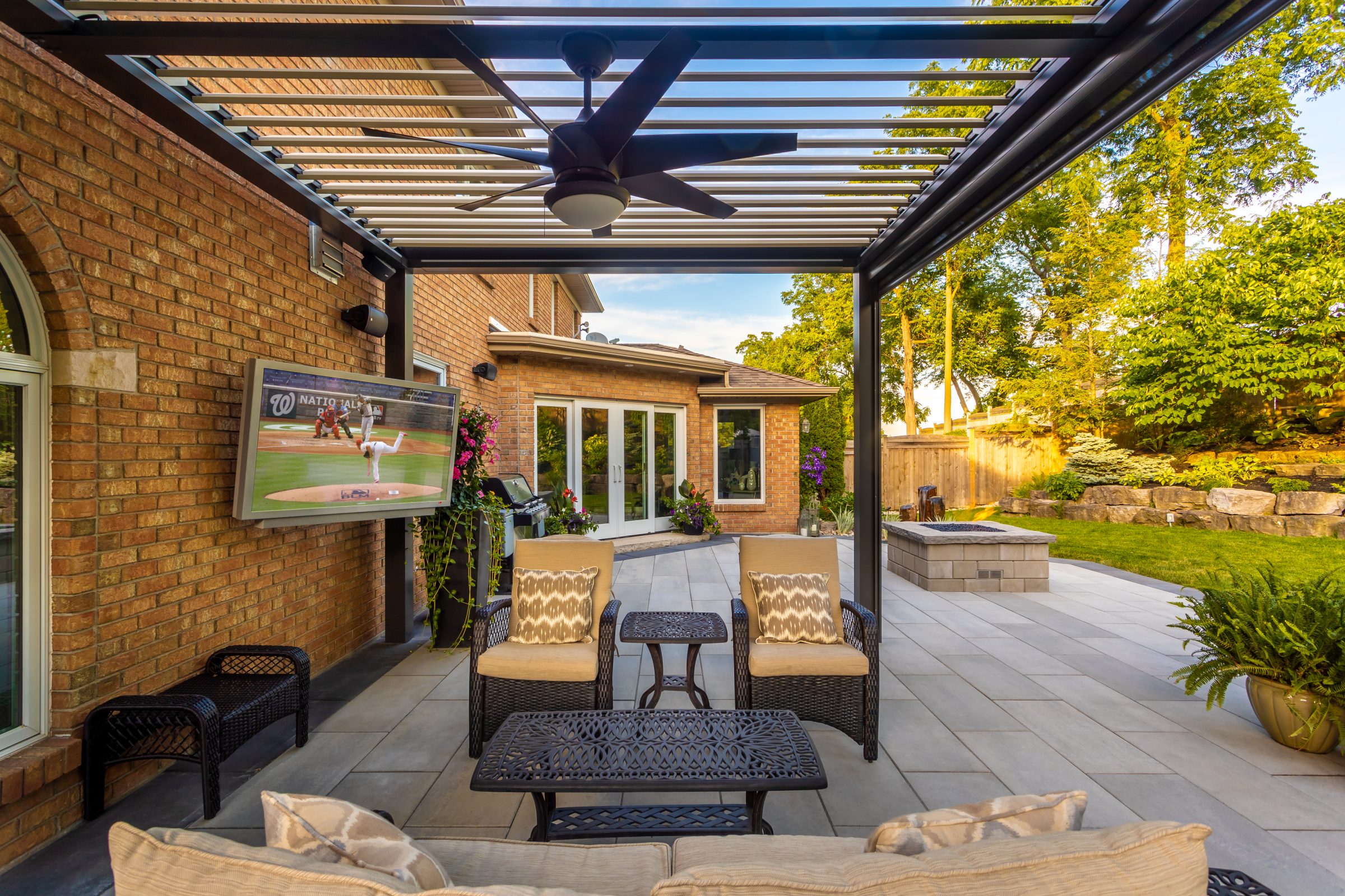 Outdoor patio with TV and seating area.