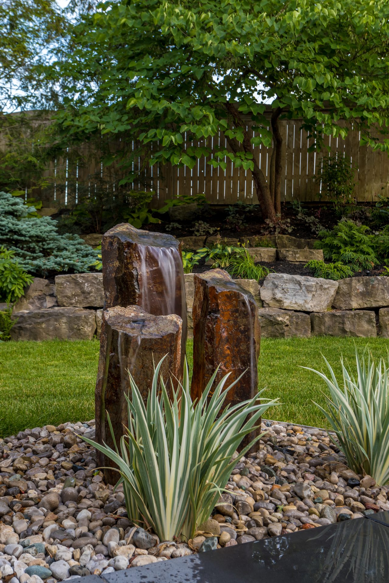 Garden fountain with rocks and greenery