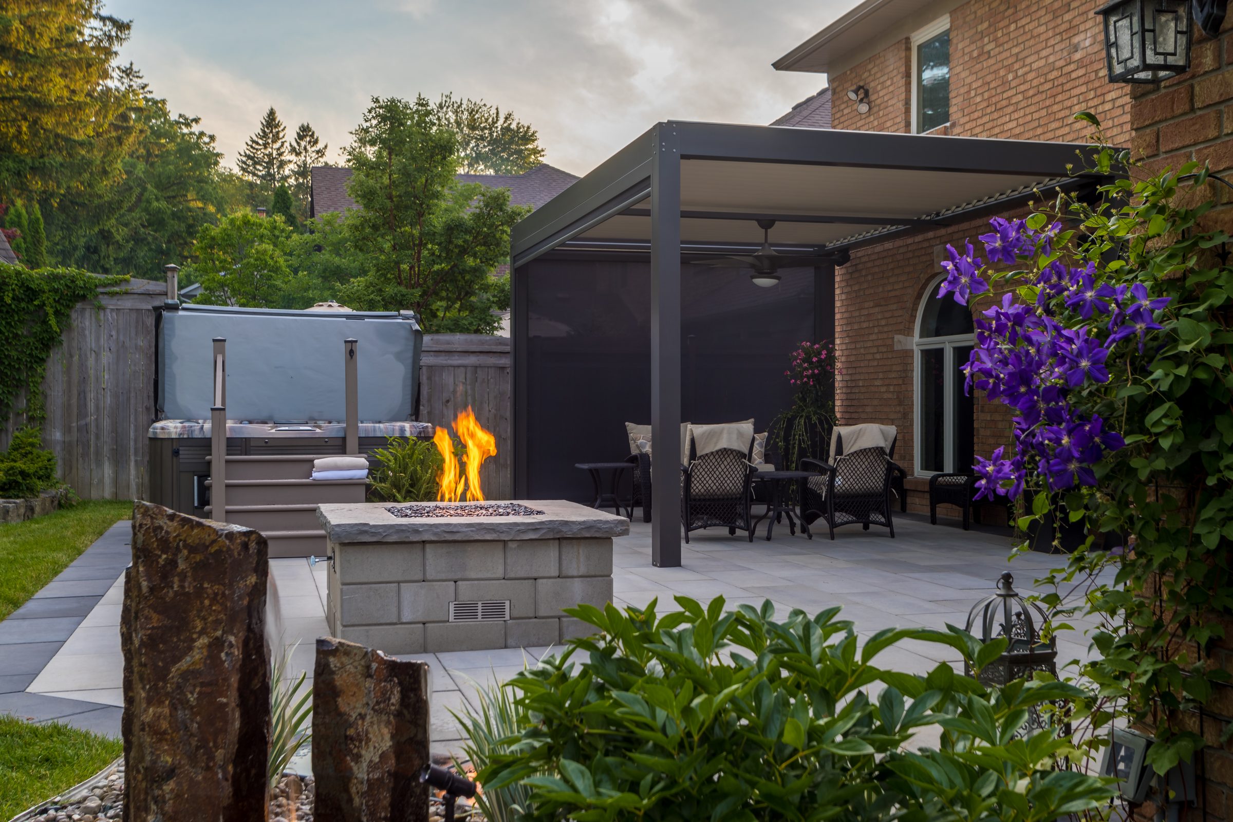 Backyard patio with fire pit and pergola.