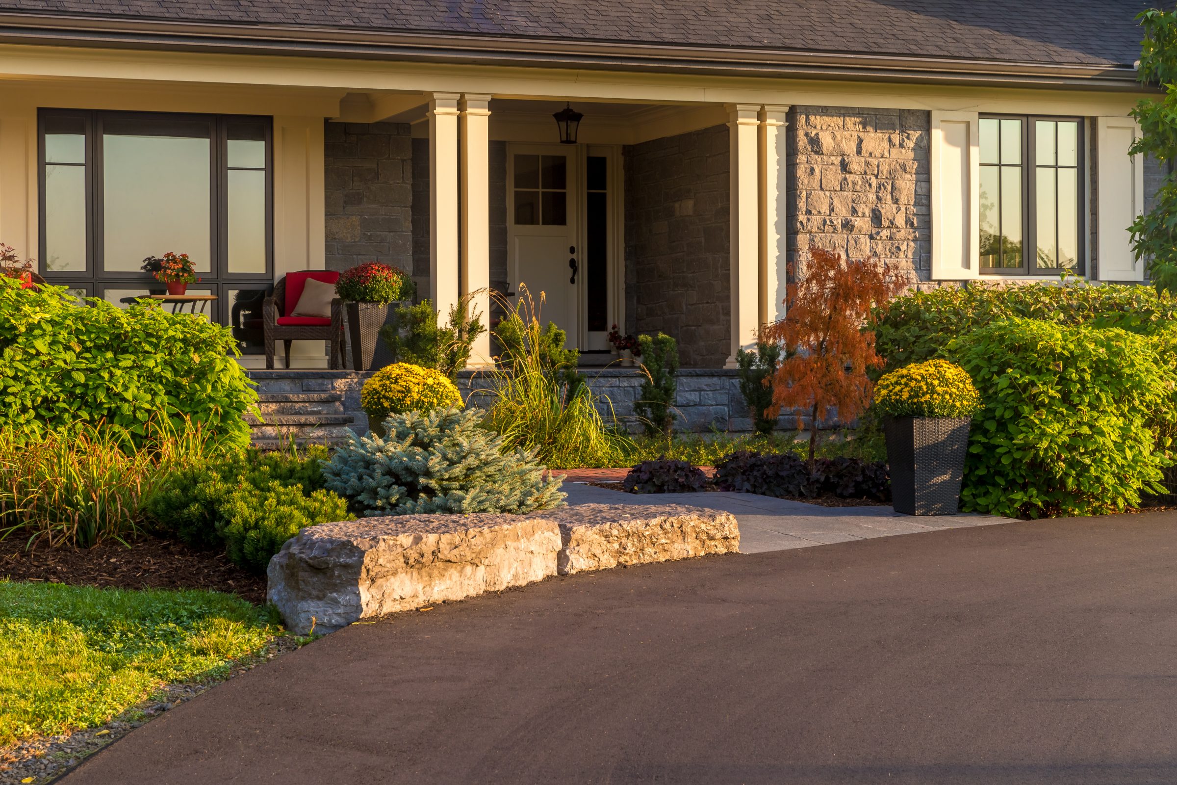 Charming house entrance with garden and stone steps.