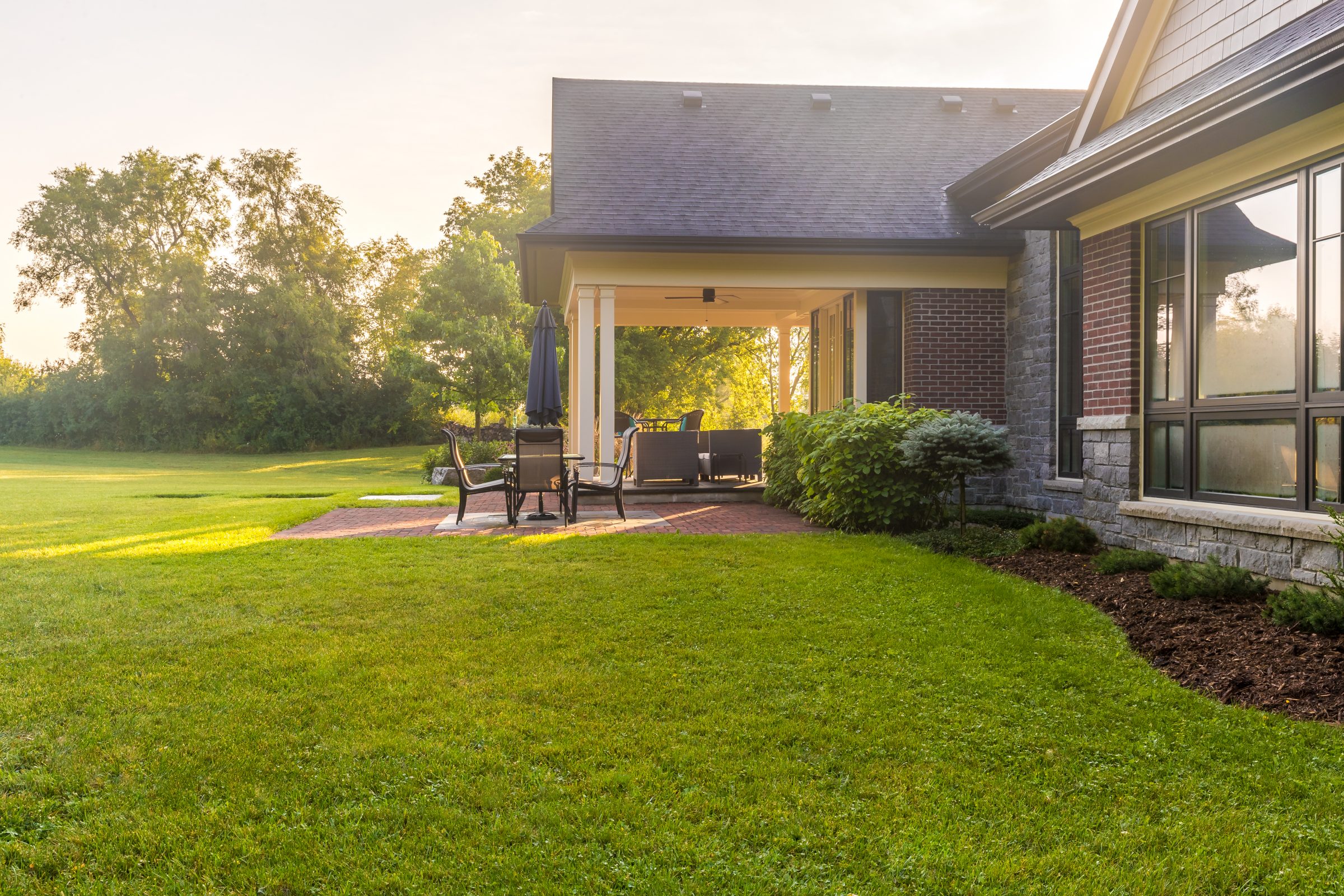 Sunny backyard with patio and greenery