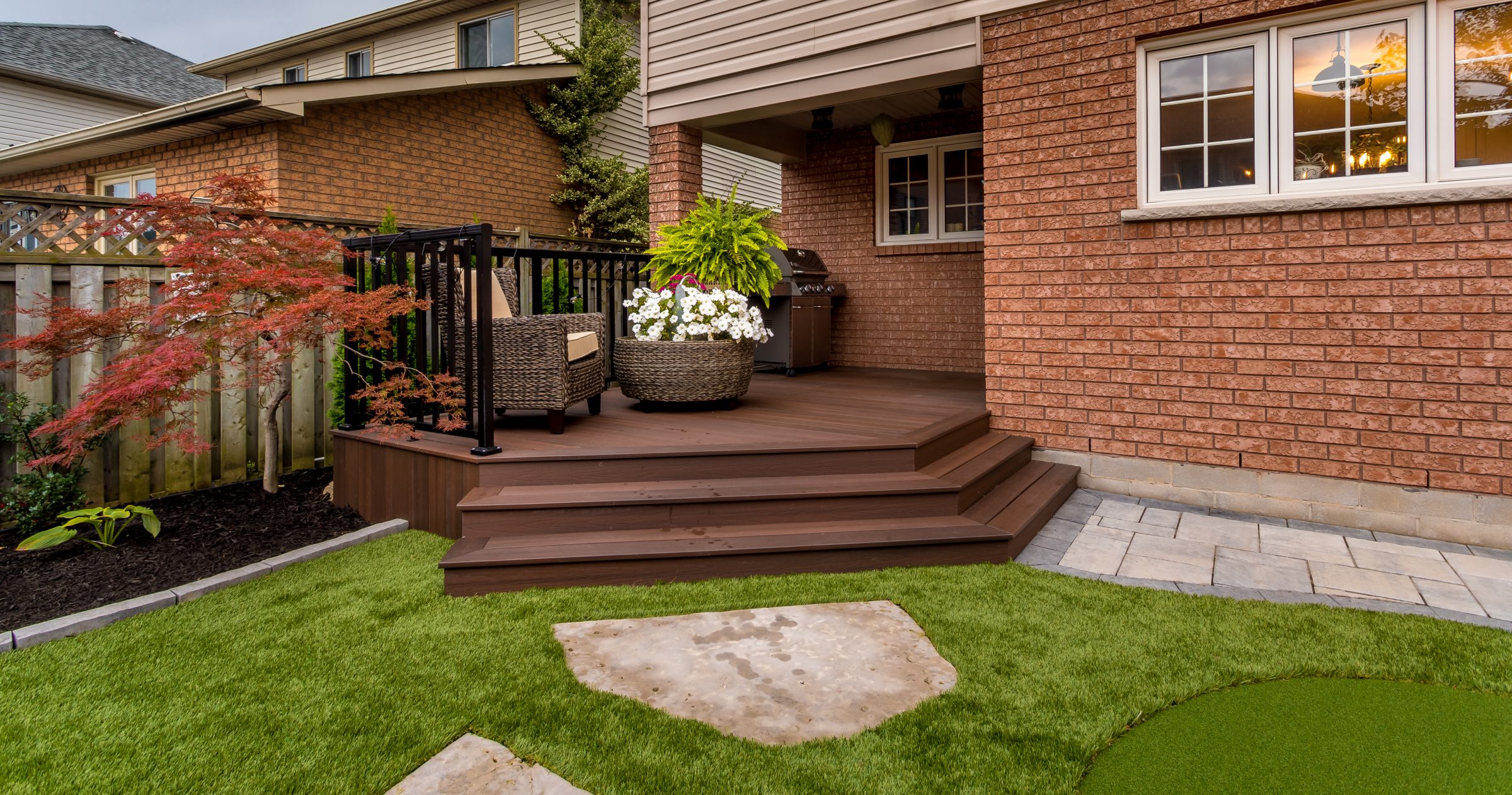 Cozy backyard patio with plants and furniture