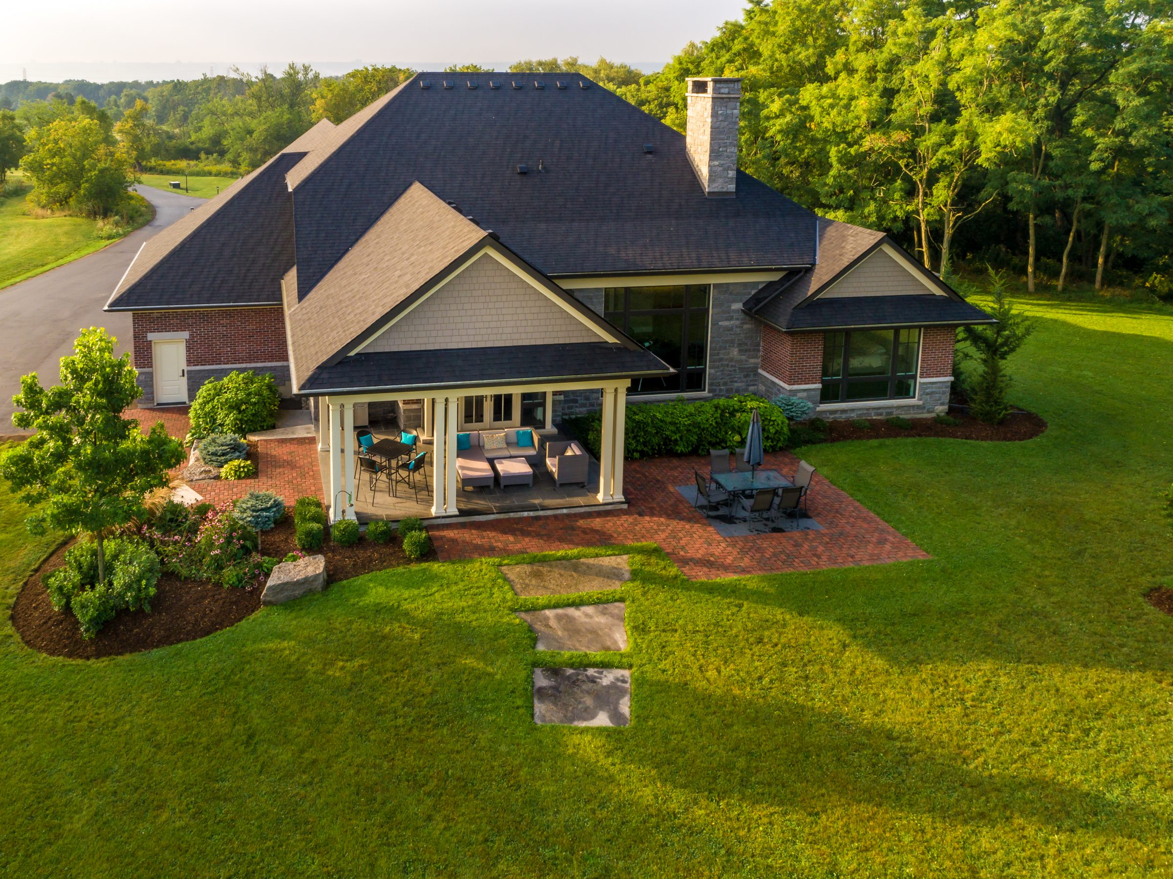 Aerial view of brick house with patio.