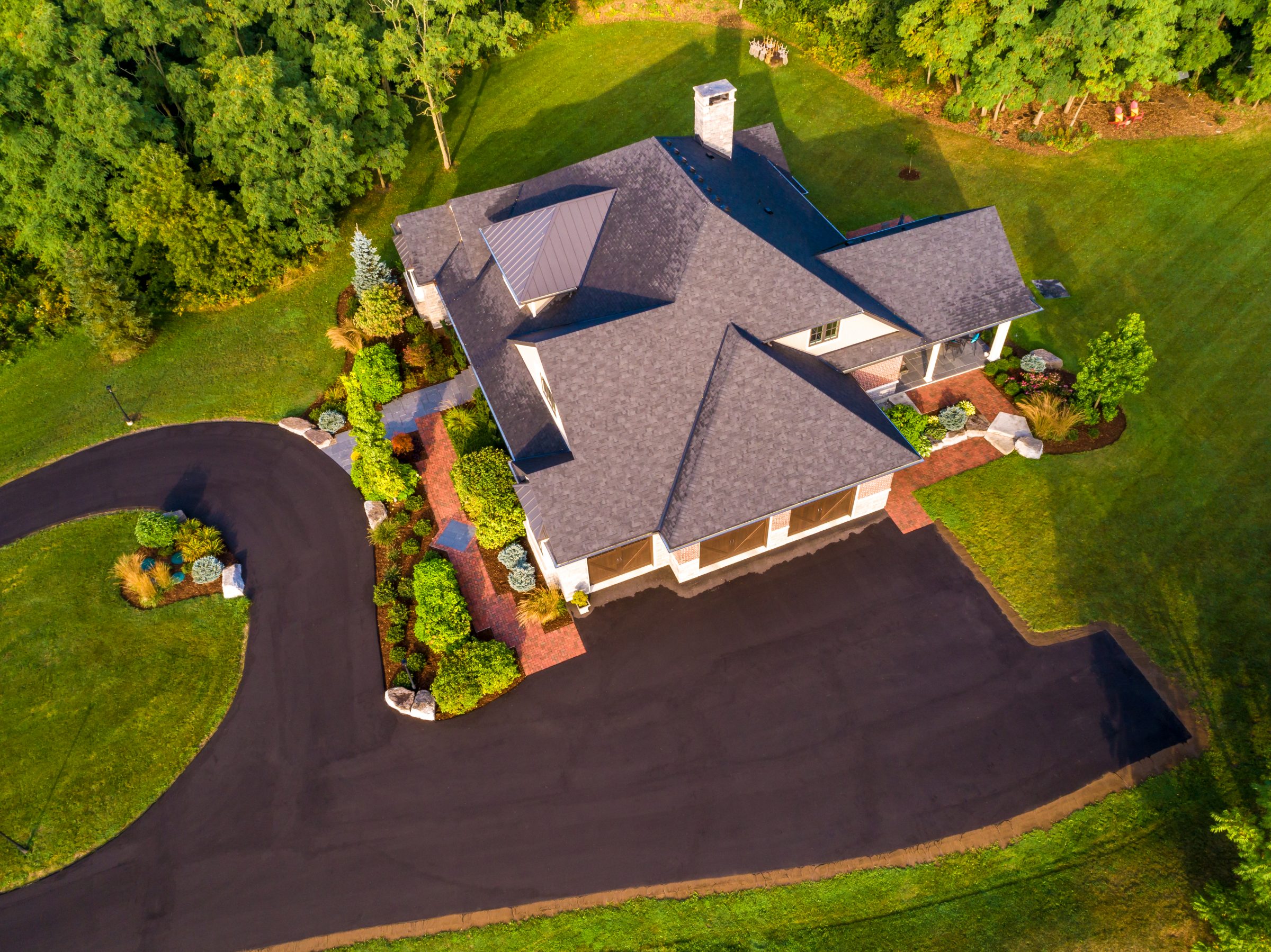 Aerial view of house and landscaped garden.