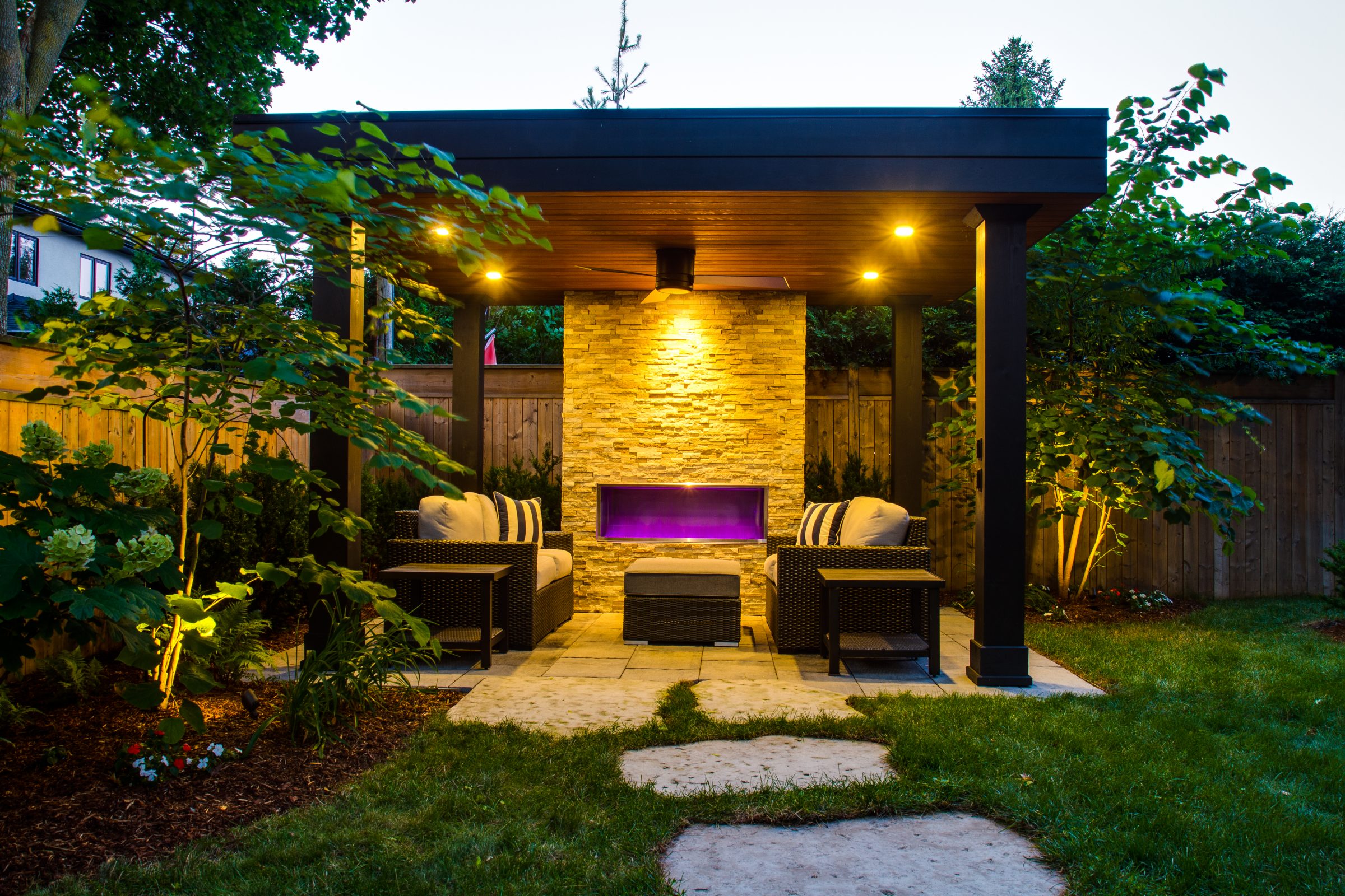 Outdoor patio with seating and illuminated fireplace