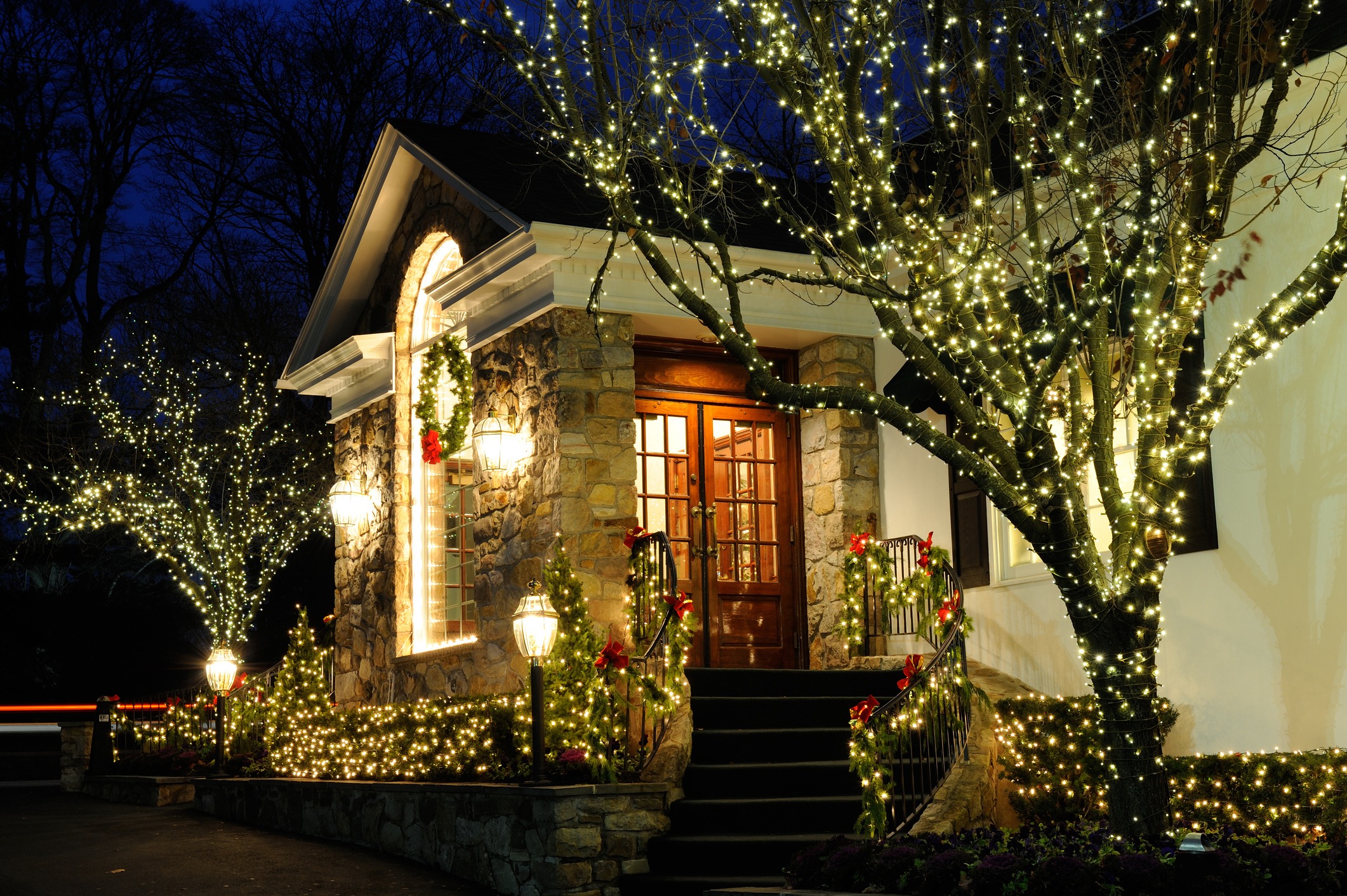 House decorated with Christmas lights and wreaths.
