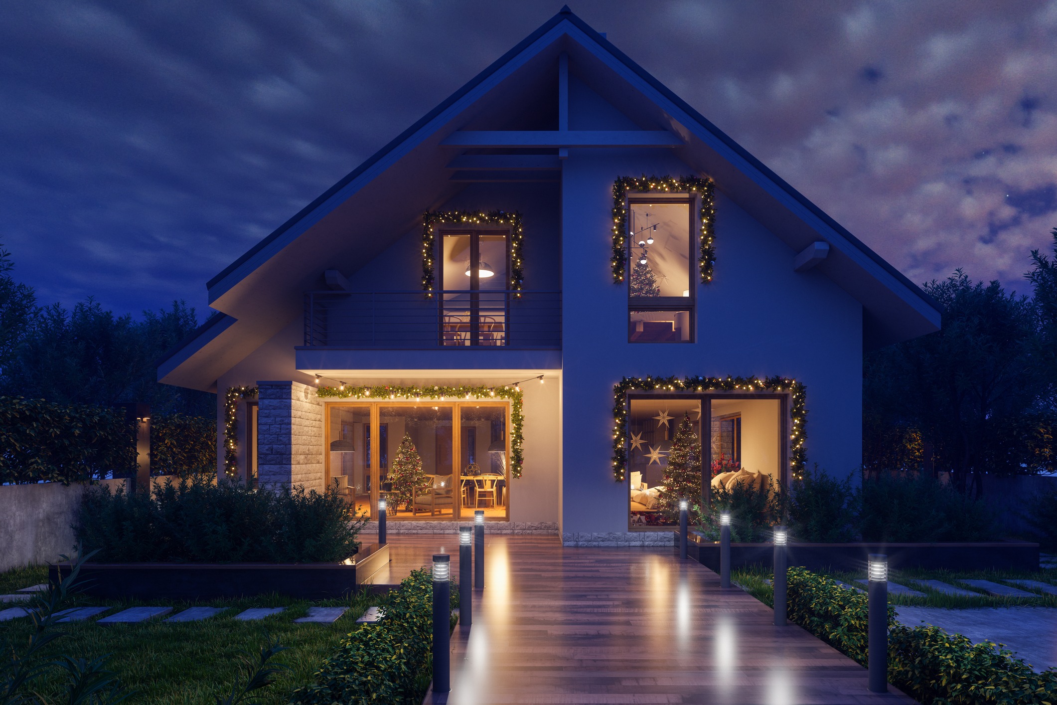 House decorated with Christmas lights and tree at night.