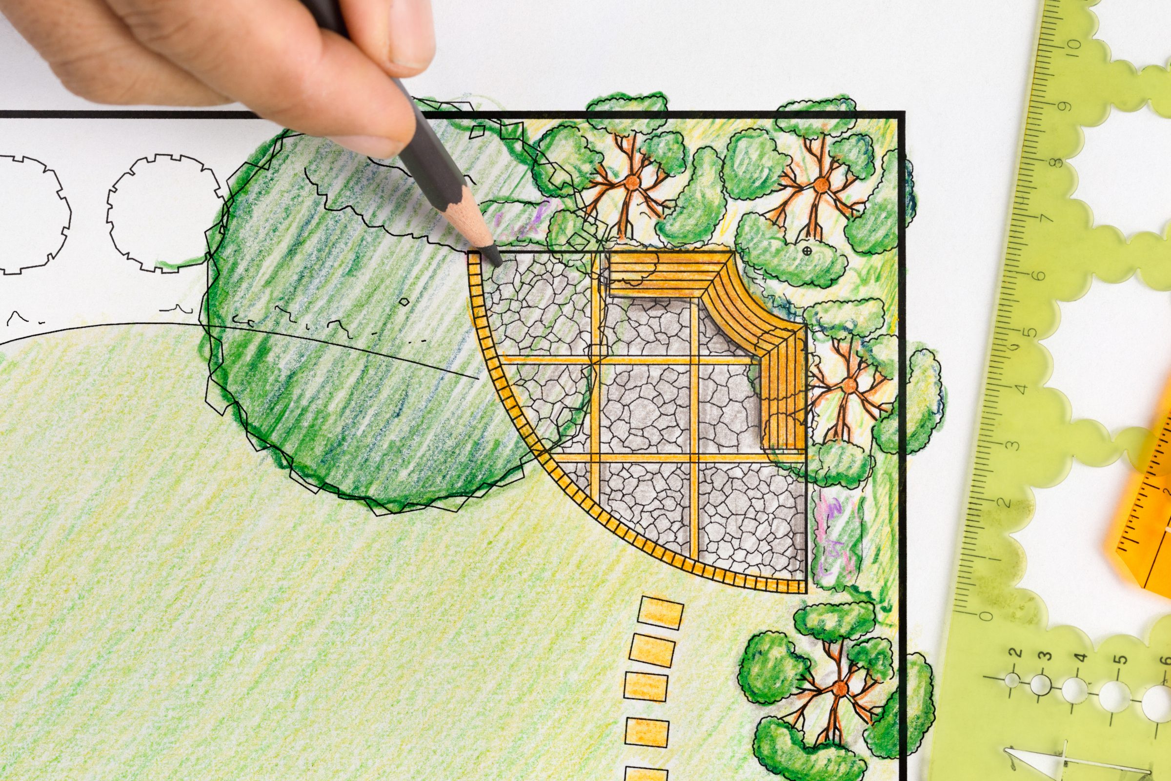 Hand drawing landscape design plan with pencils.